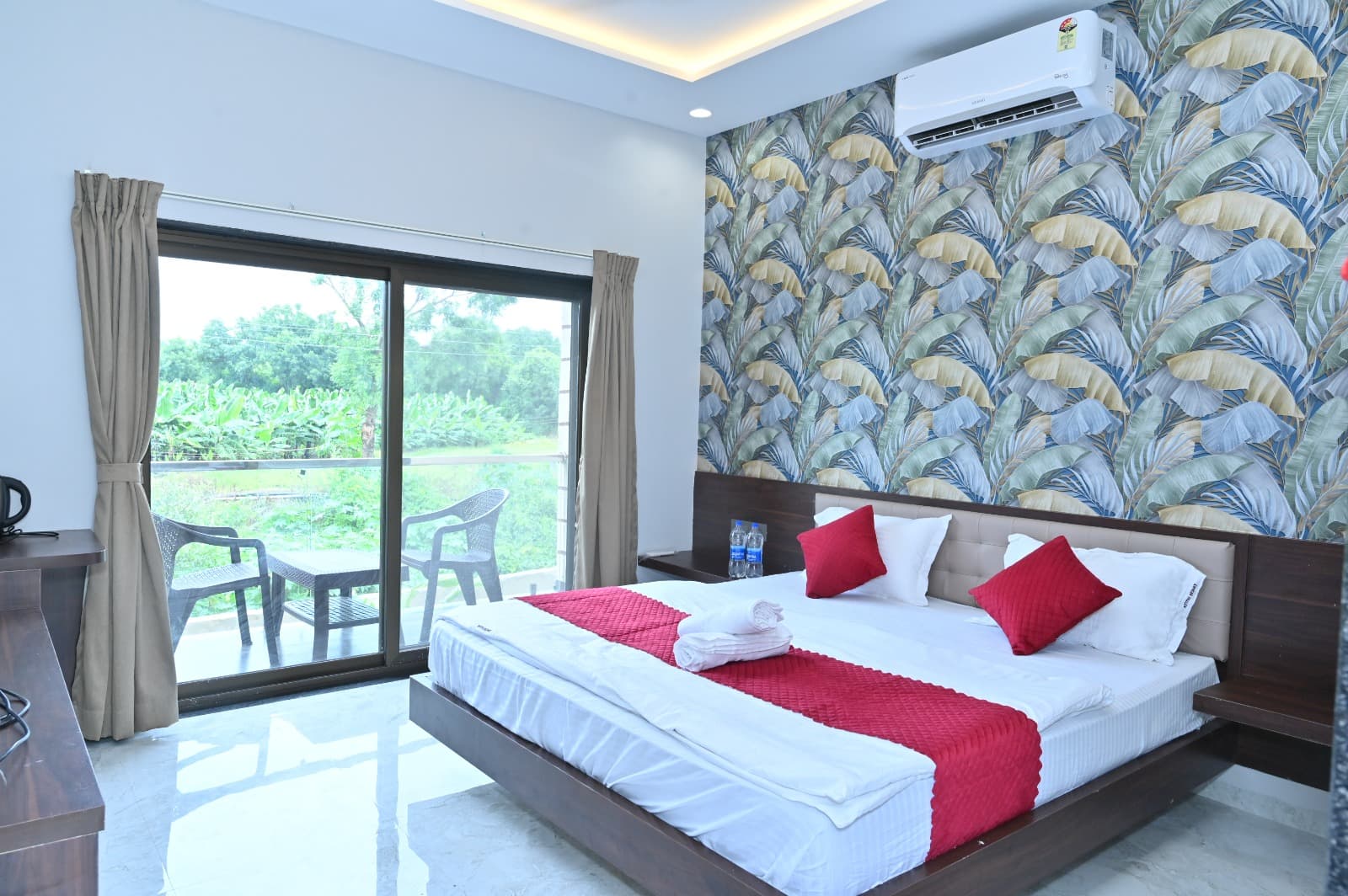 Super Deluxe Room bedroom and balcony at Hotel Atithi Resort Ellora